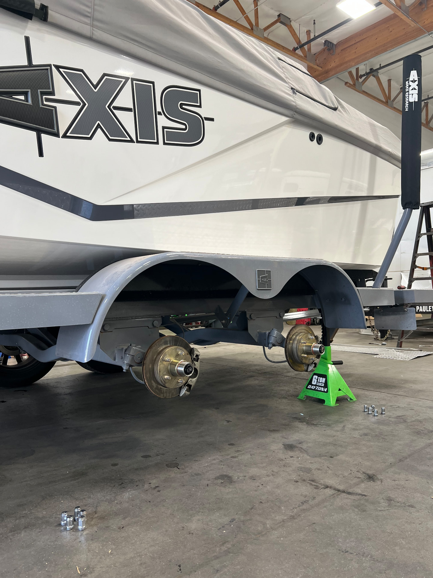 Boat trailer on jack stands with fresh brake and hub service completed