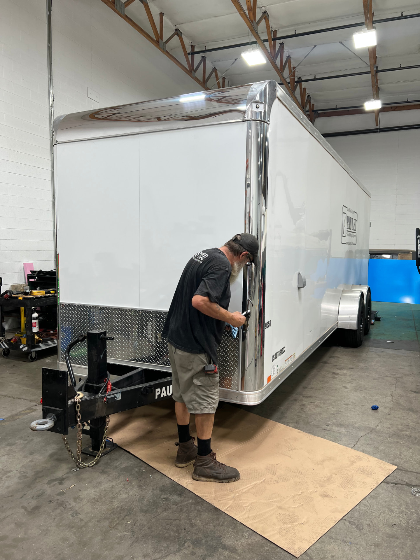 SPARKS technician working on an enclosed trailer in the shop