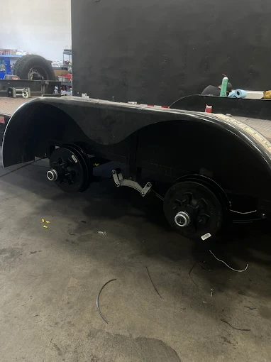 Tandem trailer axles with brakes exposed during service