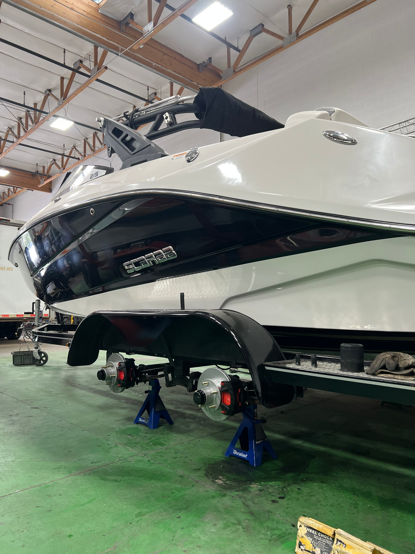 Scarab 215 boat trailer up on jack stands for brake and hub service